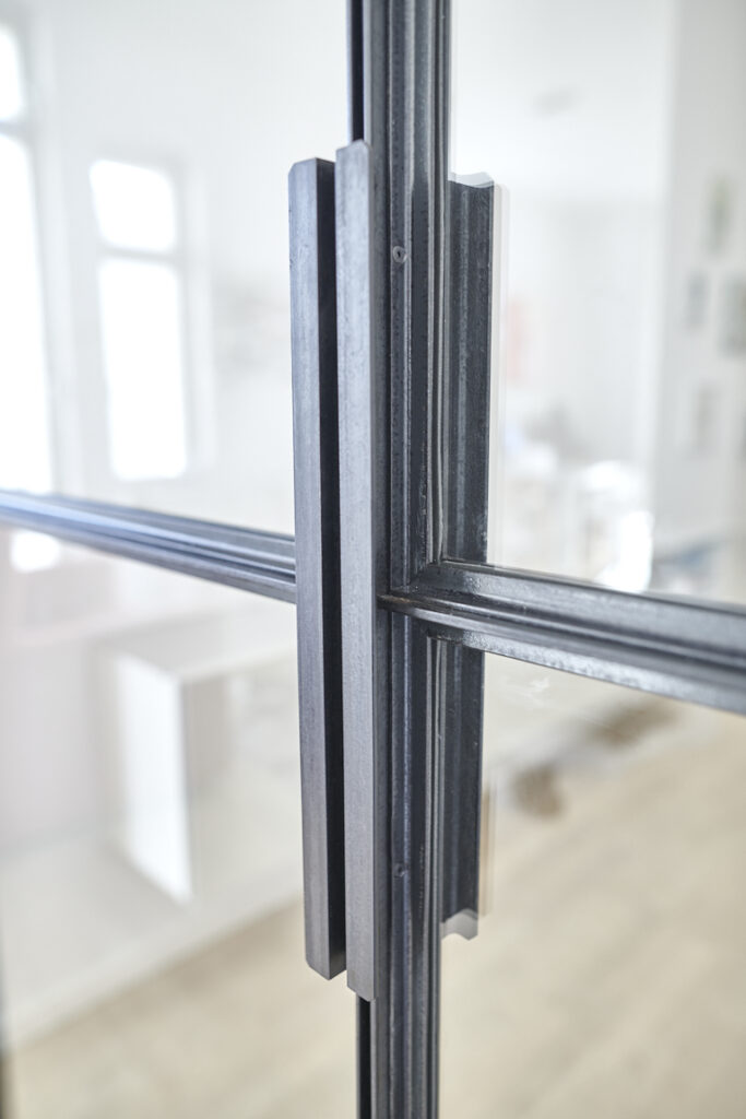 Von Hand gefertigte Griffe für Metall Raumteiler aus Winkelstahl-Profil. Detailansicht für Griffe und Tür.